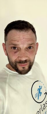 Man with short hair and beard in a white shirt at a construction networking Leeds event.
